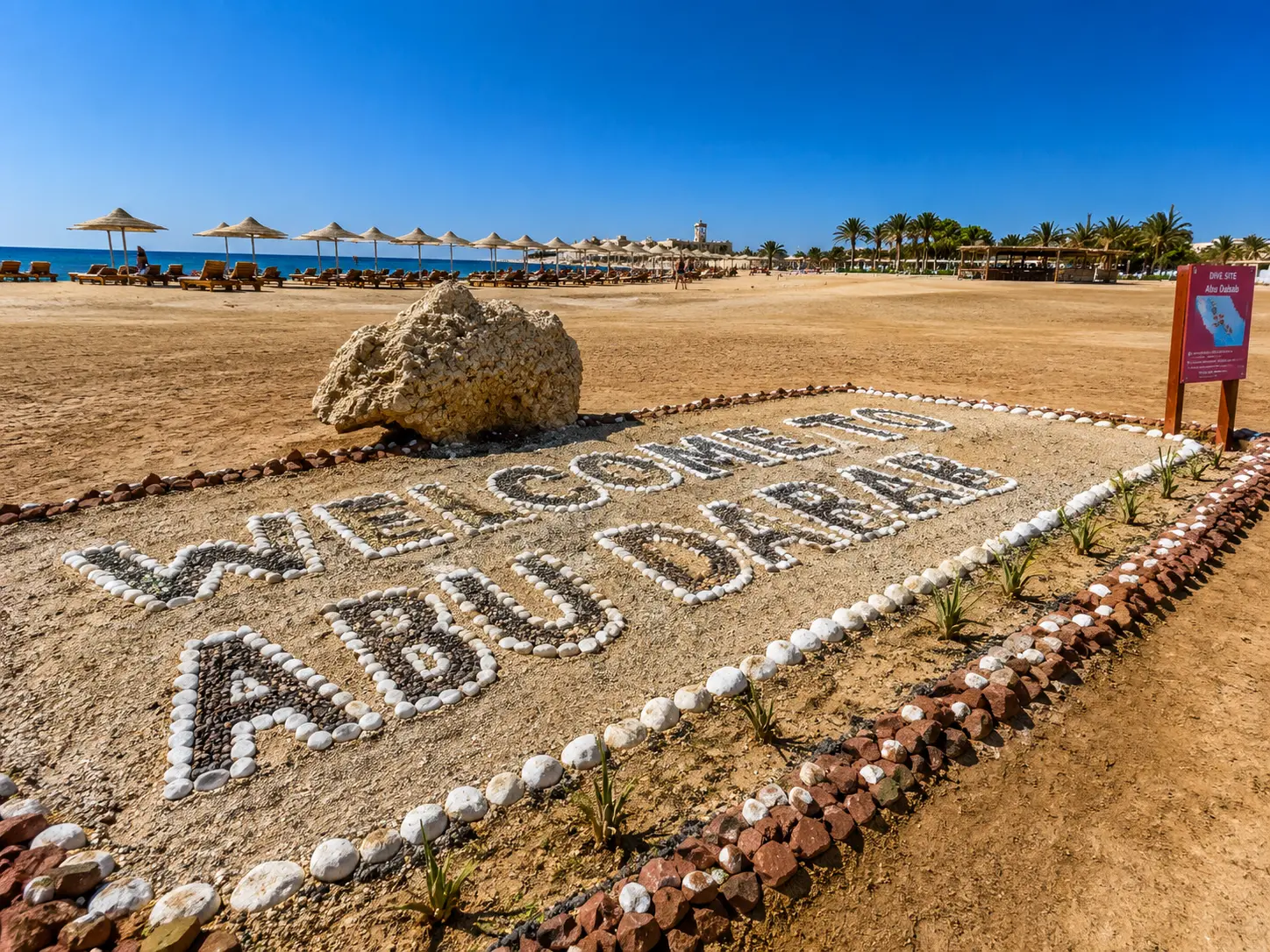 Beach entrance at Abu Dabab with parasols and loungers by the sea